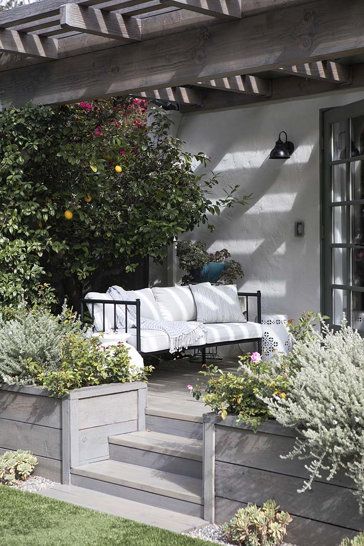 Outdoor wooden couch with white cushions