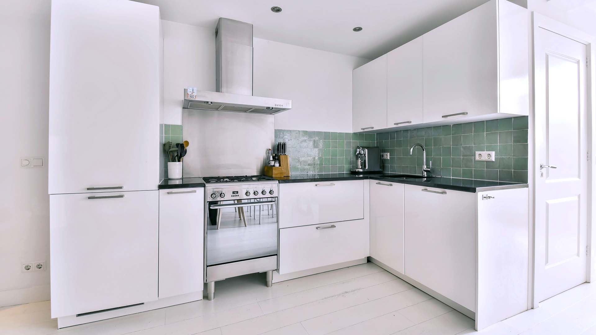 a white kitchen with white appliances and white cabinets